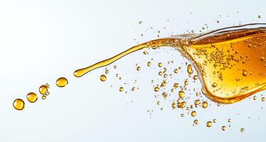 Golden drops of honey splash against a light background, creating a dynamic display. The fluid movement highlights the thick, viscous nature of this natural sweetener, emphasizing its rich texture. photo