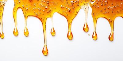 Golden honey cascades in thick splashes, creating delicate droplets on a clean surface. The warm light highlights the smooth texture and rich color, evoking a sense of sweetness and natural goodness. photo