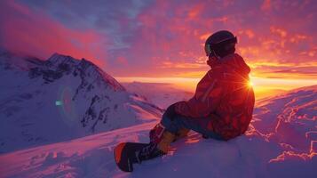 A snowboarder sits on a snow covered slope, gazing at the vibrant sunset casting warm hues across the snow and mountains, creating a stunning winter landscape. photo