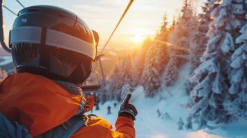 A person in an orange jacket, gestures toward the setting sun while riding a ski lift surrounded by snow covered trees on a winter evening. photo