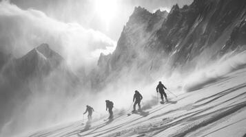 A group of four skiers makes their way through deep snow while mountain peaks rise sharply in the background, captured in a black and white setting that enhances the atmosphere. photo
