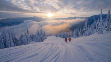 Two skiers navigate a powdery slope with pristine snow, while a colorful sunset illuminates the clouds and mountains in the distance, creating a serene winter landscape. photo