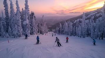 Various skiers navigate down a snow covered slope surrounded by tall, frosty trees as the sun sets, creating a vibrant backdrop and serene atmosphere. photo