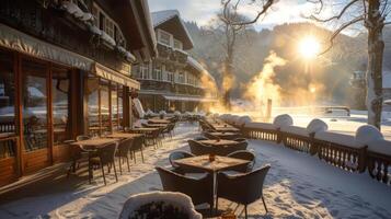 Snow blankets the outdoor seating area of a mountain cafe as sunlight breaks through the trees, creating a serene winter atmosphere on a clear morning. photo