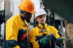 professional engineer team checking product quality control in metal workshop production line photo