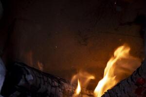 A burning flame with charcoals in the stove photo