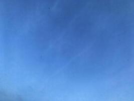 A view of a bright blue sky with white clouds, for background photo