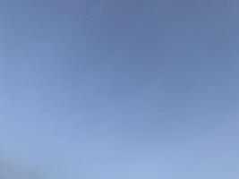 A view of a bright blue sky with white clouds photo