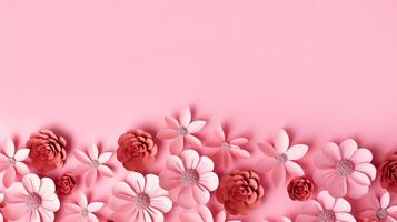 Handcrafted paper flowers in various shades of pink and red, intricately designed and arranged along the bottom of smooth pastel pink background. Perfect for romantic, artistic, or photo