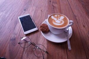 coffee and smartphone on wooden table photo