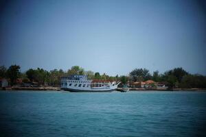 a boat is docked in the water near a beach photo