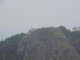 a mountain with a large rock on top photo