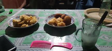 two bowls of food on a table with a drink and a comb photo