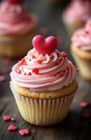 Cupcakes with pink frosting and hearts on top photo