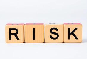 A set of cube blocks spelling out the word RISK, symbolizing uncertainty, decision making, and strategic challenges photo