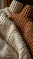 Three sweaters are stacked on top of each other photo
