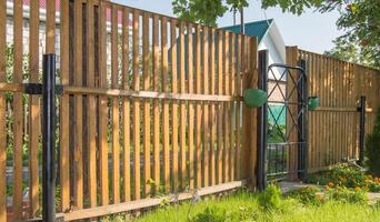A wooden fence with a gate and a gate photo