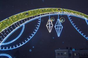 A large arch with lights and decorations on it photo