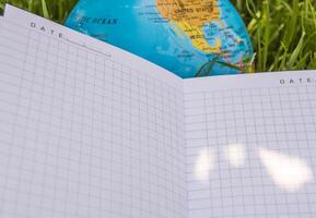 A notebook with a globe on it photo