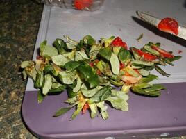 a knife is cutting up a bunch of strawberries photo