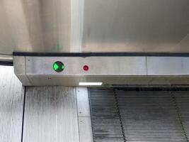 Green Arrow Directional Indicator on an Airport Escalator. photo