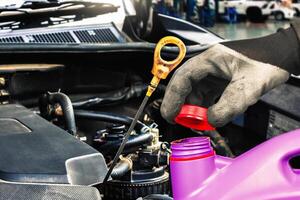 Checking engine oil level or changing engine oil in vehicle maintenance , Automotive maintenance concept photo