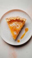 Slice of pie with layers of golden peach jam and creamy vanilla filling. photo