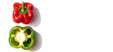 Sliced red and green bell peppers are showcased on a white surface, emphasizing their vibrant colors and fresh appeal perfect for health-focused content. The arrangement invites culinary creativity photo