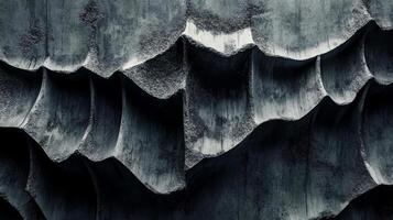 Rough, dark concrete displays an abstract arrangement of layered textures creating depth and interest. The patterns present a modern and industrial aesthetic photo
