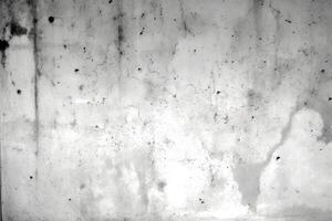 An abstract background featuring a textured concrete surface with varying shades of gray and irregular patterns. It creates a unique visual appeal with its rugged appearance and subtle details photo