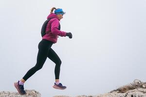 Trail Runner in Misty Mountain Landscape photo