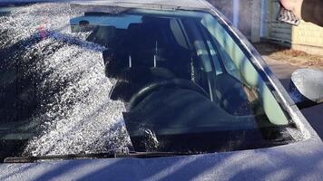 Man using Car Snow Brush to remove snow from the car video