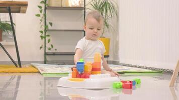 Baby playing with building blocks on activity table video