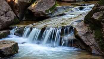 Serene Waterfall Cascading Over Mossy Rocks photo