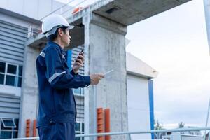maintenance and inspector. Maintenance engineers are using walky talky to inform the results of inspection of buildings and structures. Irrigation engineers are exploring sluice photo