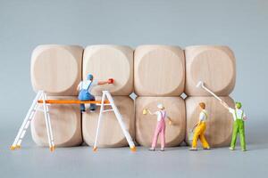 Miniature Painters at Work on Wooden Blocks photo