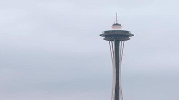 Aerial view of the Space Needle in Seattle, USA, with smooth camera motion highlighting its design against an overcast sky. video