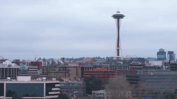 Aerial view of downtown Seattle with the Space Needle, high rise buildings, construction cranes, and tree lined areas under a cloudy sky. video