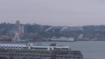 Aerial view of Seattle's downtown featuring Smith Tower, modern skyscrapers, light traffic, and steam rising under a cloudy sky. video