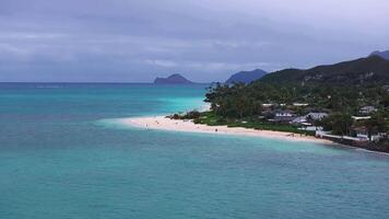 Aerial view of Lanikai Beach on Oahu Island, Hawaii, with turquoise waters, white sand, Mokulua Islands, and a slow pan along the coastline. video