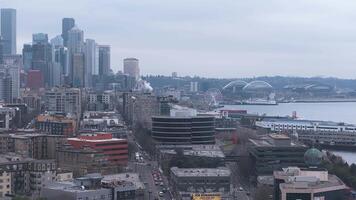 Aerial view of Seattle showing downtown, the waterfront, Seattle Great Wheel, Lumen Field, and Port of Seattle cranes with a slow pan motion. video