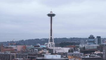 Aerial view of downtown Seattle with the Space Needle, modern buildings, and Pacific Science Center. Slow pan highlights skyline under overcast sky. video