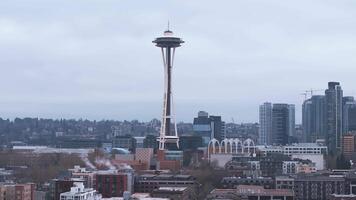 Aerial view of downtown Seattle featuring the Space Needle, modern skyscrapers, construction cranes, and an overcast sky with visible steam rising. video