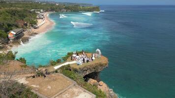 Aerial view of wedding ceremony on the cliff by the ocean in Bali, Indonesia. video