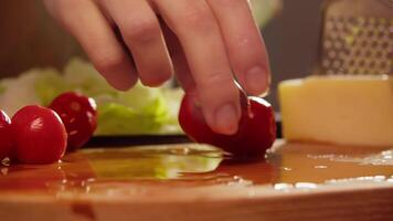 Cherry tomatoes, which are delicious and nutritious addition to low-calorie Mediterranean salad, are neatly arranged on cutting board. video