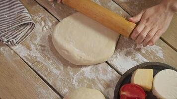Chef's skilled hands expertly roll out the dough using skipping rope, giving it softness and elasticity. They then turn it over to other side. video