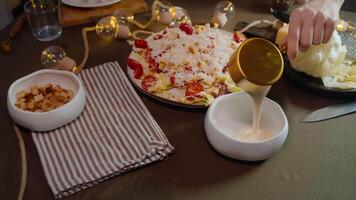 Culinary chef pours sour cream-based sauce made with garlic and aromatic Italian herbs into saucepan. delicious white sauce is used in restaurant cuisine to accompany meat and fish dishes, as well as salads. video