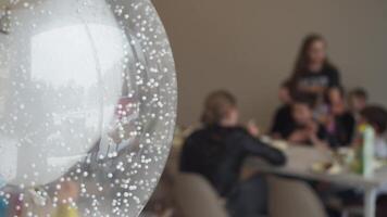 White and cream-colored balloons, filled with helium, drift through the air, creating a backdrop for the joyous celebration of a child's birthday. video