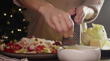 Chef grates clove of garlic and adds it to delicious salad dressing, giving the dish a spicy flavor. process of making Caesar salad dressing. video