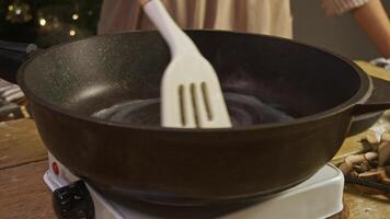 Experienced housewife uses butter to grease frying pan, so that food is more flavorful and does not stick or burn while cooking. Close up. video